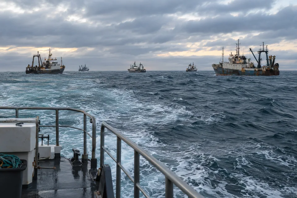 AI-generated illustration: Several fishing vessels spread across a gray South Atlantic swell.