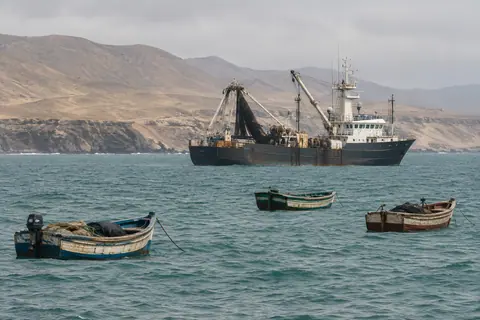 AI-generated illustration: An industrial fishing vessel anchored off Peru’s arid coast.